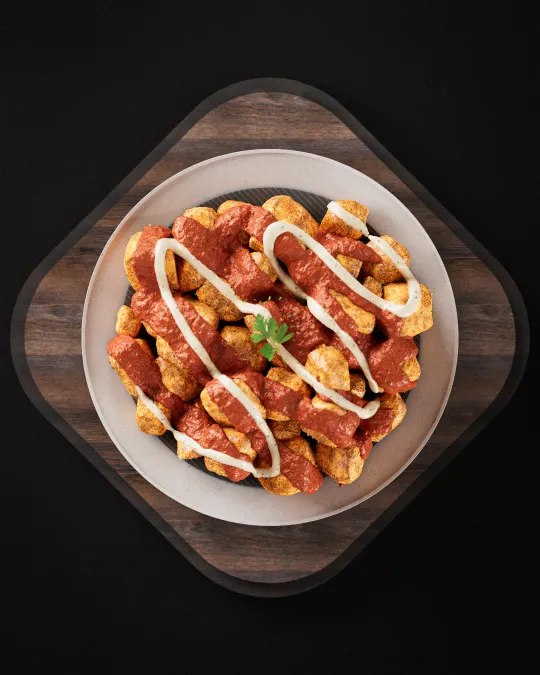 Cinematic 3D render of patatas bravas with sauce. Modeled in Maya, textured in Photoshop, rendered in V-Ray.