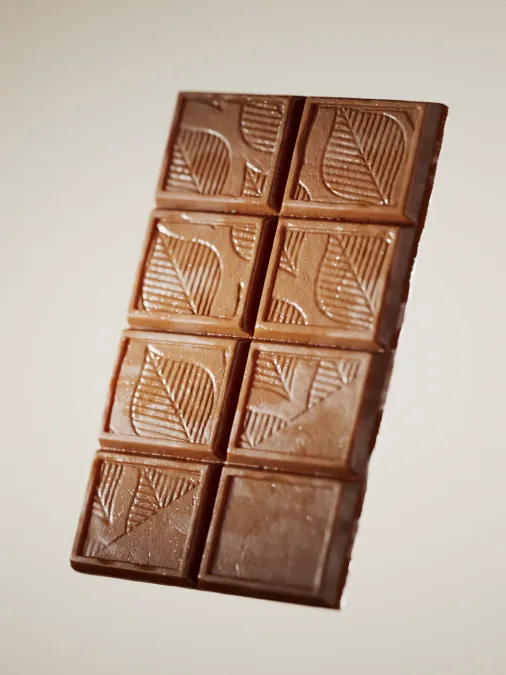 Glossy 3D render of a dark chocolate bar. Sculpted in ZBrush, rendered in V-Ray, retouched in Photoshop.