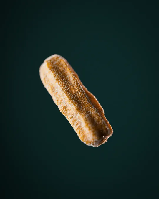 Photorealistic 3D render of a churro with sugar. Maya modeling, ZBrush sculpting, V-Ray render.