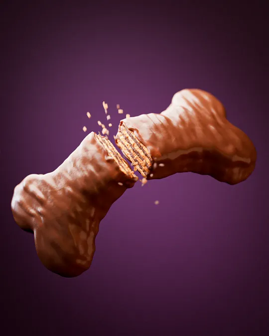Glossy 3D render of a bone-shaped candy. Maya, V-Ray, Photoshop.
